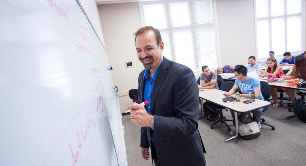 Eberhardt School of Business professor at white board in classroom