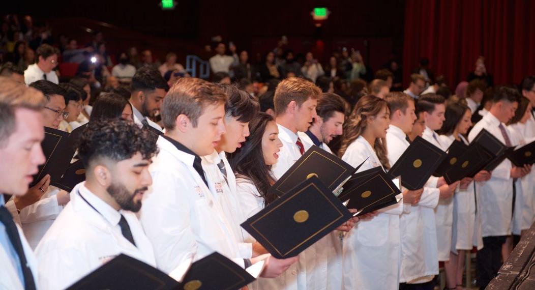 students reading the oath of professionalism