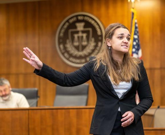 A law student gives a practice opening argument.